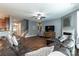 Spacious living room with hardwood floors, ceiling fan, fireplace, and comfortable leather sofa at 4924 Riverdale Dr, Charlotte, NC 28273