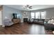 Cozy living room with hardwood floors, fireplace, comfortable seating, and large windows with natural light at 4924 Riverdale Dr, Charlotte, NC 28273