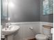 Chic powder room featuring a pedestal sink, toilet, and modern wainscoting at 4924 Riverdale Dr, Charlotte, NC 28273