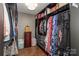 Large walk in closet with hanging clothing and shelf storage at 4924 Riverdale Dr, Charlotte, NC 28273