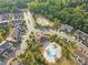 Aerial shot of the neighborhood, showing the pool, clubhouse, pond, and lush landscaping at 526 Hunters Dance Rd, Fort Mill, SC 29708