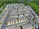Overview of a residential community featuring numerous townhomes, green spaces, and a community pool at 526 Hunters Dance Rd, Fort Mill, SC 29708