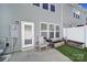 The backyard features artificial grass and patio with an exterior door to the home at 526 Hunters Dance Rd, Fort Mill, SC 29708