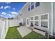 The backyard features artificial grass, a cozy patio, and rear exterior views at 526 Hunters Dance Rd, Fort Mill, SC 29708
