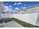 This backyard includes artificial grass, a patio, and a pristine white fence at 526 Hunters Dance Rd, Fort Mill, SC 29708