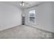 Minimalist bedroom with carpet flooring, ceiling fan, and window views at 526 Hunters Dance Rd, Fort Mill, SC 29708