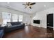 Bright living room featuring hardwood floors, a blue sofa, and ample natural light at 526 Hunters Dance Rd, Fort Mill, SC 29708