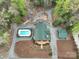 Overhead aerial view showcasing pool, manicured landscaping, charming footbridges and cabin at 528 Manchester Rd, Mount Gilead, NC 27306