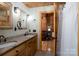 Bathroom featuring double sinks, granite countertops, and rustic fixtures, offering a luxurious feel at 528 Manchester Rd, Mount Gilead, NC 27306