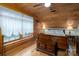 Bedroom with wood-paneled walls, a wooden bed frame, and bright natural light from a window at 528 Manchester Rd, Mount Gilead, NC 27306