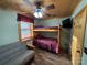 Comfortable bunk bed room with a futon, wood ceiling, and wood-look floors at 528 Manchester Rd, Mount Gilead, NC 27306