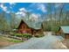 Charming log cabin with a detached garage, stone accents, and well-maintained gravel driveway at 528 Manchester Rd, Mount Gilead, NC 27306