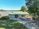 Picturesque waterfront home with green roof and expansive grounds, offering stunning lake views and outdoor living at 528 Manchester Rd, Mount Gilead, NC 27306