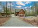 Charming cabin with a stone foundation, gravel driveway, and outdoor hot tub area perfect for relaxation at 528 Manchester Rd, Mount Gilead, NC 27306
