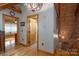 Hallway with hardwood floors and access to multiple rooms, highlighted by decorative lighting at 528 Manchester Rd, Mount Gilead, NC 27306