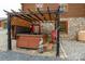 Covered hot tub with a stone backdrop, offering a relaxing retreat with outdoor lights and seating at 528 Manchester Rd, Mount Gilead, NC 27306