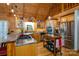 Modern kitchen with stainless steel appliances, custom cabinets, and a view of the upstairs loft at 528 Manchester Rd, Mount Gilead, NC 27306