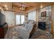 Cozy living room with stone fireplace, wood ceiling, reclining chairs, and outdoor access at 528 Manchester Rd, Mount Gilead, NC 27306
