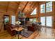 Inviting living room featuring a stone fireplace, hardwood floors, comfortable seating, and natural light at 528 Manchester Rd, Mount Gilead, NC 27306