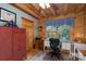 Office space with wood ceiling beams, spacious desk, and natural light from the window at 528 Manchester Rd, Mount Gilead, NC 27306