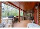 Outdoor kitchen with stone counter, built-in grill, mini fridge, and bar seating; ideal for entertaining guests at 528 Manchester Rd, Mount Gilead, NC 27306