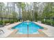 Private in-ground swimming pool surrounded by lush landscaping, perfect for summer relaxation at 528 Manchester Rd, Mount Gilead, NC 27306