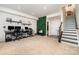 Finished basement with carpet, featuring dual workstation desks, stairs, and ample space for entertainment at 532 Billingsley Rd, Charlotte, NC 28211