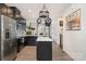 Contemporary kitchen with black cabinetry, white countertops, stainless steel appliances, and wood-look flooring at 532 Billingsley Rd, Charlotte, NC 28211