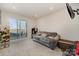 Cozy living room with plush sofa, sliding doors to balcony, and carpet at 532 Billingsley Rd, Charlotte, NC 28211