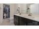 Main bathroom features a double sink vanity, walk-in shower, a mirror, and convenient access to a closet at 532 Billingsley Rd, Charlotte, NC 28211