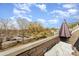 Exterior of private rooftop balcony with patio seating, umbrella for shade, and neighborhood views at 532 Billingsley Rd, Charlotte, NC 28211