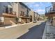 A modern townhouse community featuring private garages and balconies along a quiet street, with a focus on contemporary design at 532 Billingsley Rd, Charlotte, NC 28211