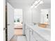 Well-lit bathroom boasts double sinks and a door leading to the main bedroom at 5924 Carrollton Ln, Charlotte, NC 28210
