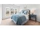 Comfortable bedroom with a bed, bedside tables, lamps, and natural light, creating a relaxing space at 5924 Carrollton Ln, Charlotte, NC 28210