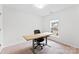 Bright bedroom featuring neutral carpet, natural light, and a versatile workspace with desk and chair at 5924 Carrollton Ln, Charlotte, NC 28210