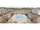 Aerial view of a community pool area with a large pool, poolside seating, and shaded cabanas for residents at 5924 Carrollton Ln, Charlotte, NC 28210