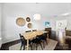 Dining area with hardwood floors, modern table, and access to the living area at 5924 Carrollton Ln, Charlotte, NC 28210