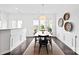 Bright dining area with modern table, hardwood floors, neutral walls, and backyard view at 5924 Carrollton Ln, Charlotte, NC 28210
