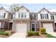 Charming townhome featuring brick accents, a one-car garage, and neatly maintained landscaping in a desirable community at 5924 Carrollton Ln, Charlotte, NC 28210