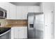 Modern kitchen featuring stainless steel refrigerator and granite countertops at 5924 Carrollton Ln, Charlotte, NC 28210