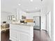 Modern kitchen with white cabinets, stainless steel appliances, and granite countertops open to the living area at 5924 Carrollton Ln, Charlotte, NC 28210