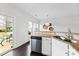 Bright kitchen features stainless steel appliances, granite countertops, and access to outdoor patio at 5924 Carrollton Ln, Charlotte, NC 28210