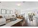 Open-concept living area with hardwood floors, modern decor, and natural light flowing into the adjacent dining space at 5924 Carrollton Ln, Charlotte, NC 28210