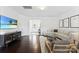 Bright living room showcasing the front door, TV, hardwood floors, and a sectional sofa at 5924 Carrollton Ln, Charlotte, NC 28210
