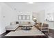 Bright living room featuring hardwood floors, neutral walls, a sectional sofa, and modern decor at 5924 Carrollton Ln, Charlotte, NC 28210