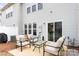 Back patio with comfortable outdoor seating, providing a cozy space for relaxing and entertaining at 5924 Carrollton Ln, Charlotte, NC 28210
