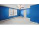 Bright blue bedroom featuring carpeted flooring and ceiling fan at 61 Brown Sw St, Concord, NC 28027