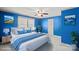 Stylishly staged bedroom in bright blue with ample space and natural light at 61 Brown Sw St, Concord, NC 28027