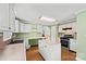Well-lit kitchen featuring sleek countertops, island, and modern appliances at 61 Brown Sw St, Concord, NC 28027