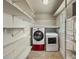 Functional laundry room with washer, dryer, and plenty of shelving for storage at 61 Brown Sw St, Concord, NC 28027